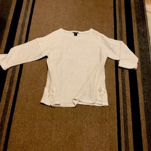 Women’s hip length top, good with leggings, detail on each side. New with tags